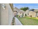 Home featuring a well-kept lawn and front door with decorative window above at 2417 Hybrid Dr, Kissimmee, FL 34758