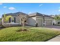 Attractive single-story residence with a lush green lawn, brick driveway, and a spacious two-car garage at 2620 Cedar Shake Ct, Oviedo, FL 32765