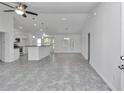 Spacious open-concept living room featuring a kitchen island, tile flooring, and natural light at 280 Marion Oaks Golf Way, Ocala, FL 34473