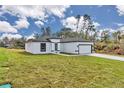 Exterior view of single-story home with a well-maintained front lawn and attached garage at 2844 Sw 162Nd Street Rd, Ocala, FL 34473