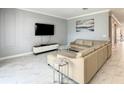 Comfortable living room with plush sectional sofa, marble floors, modern entertainment center, and stylish decor at 2908 Protagonist St, Kissimmee, FL 34746
