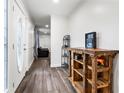 Bright entryway with modern wood-look floors and rustic wood shelving at 37224 Apiary Rd, Grand Island, FL 32735