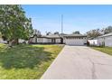 Attractive single-story home with a long driveway, spacious lawn, and a convenient two-car garage at 4100 Cannon Ct, Kissimmee, FL 34746