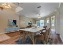 An open dining area with wood floors features neutral walls, modern furniture, and lots of natural light at 418 Laurenburg Ln, Ocoee, FL 34761