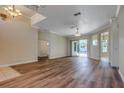 Spacious living room with hardwood floors, neutral paint, a ceiling fan and sliding glass door leading to the outdoors at 418 Laurenburg Ln, Ocoee, FL 34761