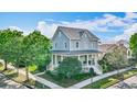 Charming two-story home with a welcoming front porch and beautifully landscaped yard at 4184 Oak St, Orlando, FL 32814