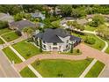 Expansive aerial shot showcases the landscaped grounds and circular brick driveway of this estate at 5447 Brookline Dr, Orlando, FL 32819