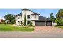 Beautiful two-story house with a three car garage and a brick driveway at 5447 Brookline Dr, Orlando, FL 32819