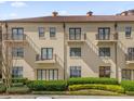 Exterior elevation of condo building showcasing balconies and manicured landscaping at 706 Westpark Way # 203, Celebration, FL 34747