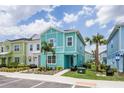 Street view of colorful modern townhomes with tropical landscaping at 8179 Coconut Pl, Kissimmee, FL 34747