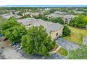 Aerial view of the condominium with parking and mature trees in the community at 114 Vista Verdi Cir # 328, Lake Mary, FL 32746