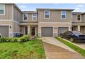 Charming townhouse with a well-maintained lawn and private garage and driveway at 1623 Mirabella Cir, Davenport, FL 33897