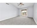 Spacious bedroom with plush carpeting and a sliding glass door providing natural light and access to outdoor views at 165 N Pearl Lake Cswy # 202, Altamonte Springs, FL 32714