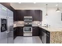 Well-equipped kitchen showcasing stainless steel appliances, granite counters, and plenty of cabinet space at 17403 Placidity Ave, Clermont, FL 34714