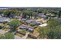 An aerial view of a cozy home surrounded by mature trees and a privacy fence at 17529 Eve Dr, Montverde, FL 34756