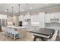 Bright kitchen with white cabinets, stainless steel appliances, an island, and a breakfast table at 1938 Filly Trl, Oviedo, FL 32765