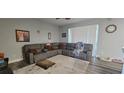 Spacious living room featuring a large sectional sofa, a ceiling fan, and lots of natural light at 2133 Korat Ln, Maitland, FL 32751