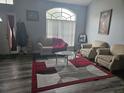 Inviting living room featuring a plush sofa, cozy chairs, and a stylish rug on the floor at 2133 Korat Ln, Maitland, FL 32751
