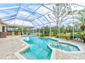 Screened in pool and spa offers a beautiful backyard escape with an outdoor kitchen and golf course views at 2439 Teton Stone Run, Orlando, FL 32828