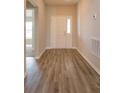 Inviting foyer with wood-look flooring and a front door with sidelight at 2447 Matterhorn Trl, Davenport, FL 33837
