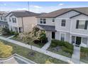 Inviting two-story townhome with manicured front lawn and sidewalk leading to the front door at 2682 Mead Ave, St Cloud, FL 34771