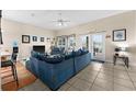 Spacious living room featuring tiled floors and access to an outdoor patio at 302 Vista Loop, Davenport, FL 33897