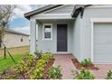 Inviting front entrance with brick pathway, manicured landscaping and a covered porch at 3845 Giorgio Dr, Winter Haven, FL 33884