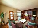 Staged living room featuring wood paneling, comfortable seating, and stylish decor at 420 W Crystal Dr, Sanford, FL 32773