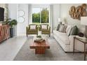 Bright living room with large windows, stylish decor, and comfortable seating at 4957 Kaia Ave, Winter Haven, FL 33884