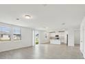 Bright, open-concept living space featuring tile flooring and sliding glass doors at 4965 Kaia Ave, Winter Haven, FL 33884