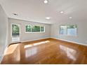 Bright living room with hardwood floors, recessed lighting, and large windows on a sunny day at 662 Lake Dr, Altamonte Springs, FL 32701