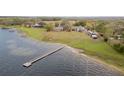 Expansive lakefront property featuring a private dock, lush green lawn, and multiple residential buildings at 9130 Laws Rd, Clermont, FL 34714