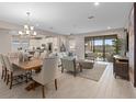 Open-concept living space featuring a dining area, living room, and kitchen with sliding glass doors at 938 Braewood Dr, Clermont, FL 34715
