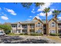 Condominium building exterior showcasing multiple units, staircases, and parking area at 1015 S Hiawassee Rd # 3514, Orlando, FL 32835