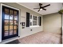 Inviting front porch with a ceiling fan, tiled floors, and a view of the front yard at 1320 Golfview St, Orlando, FL 32804