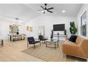 Bright living room with vaulted ceilings, modern furnishings, and a view into the dining area at 137 Stevens Ave, Chuluota, FL 32766