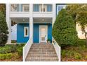 Close up of the blue exterior with white railing leading to the front door at 13838 Walcott Ave, Orlando, FL 32827