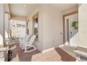 Inviting front porch with brick pavers and white rocking chairs creates a welcoming entrance to this home at 15772 Murcott Harvest Loop, Winter Garden, FL 34787