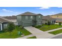 Two-story home featuring a well-maintained lawn, driveway, and a classic yet modern exterior design at 1629 Hill Park Dr, Deltona, FL 32725