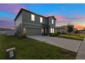 Beautiful two-story home with a lush green lawn and a spacious driveway at 1629 Hill Park Dr, Deltona, FL 32725