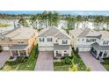 Beautiful aerial view of home with well-manicured lawn and serene lake backdrop at 17846 Adrift Rd, Winter Garden, FL 34787