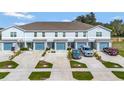 An aerial view of a well-maintained townhome community with private driveways and manicured green spaces at 3086 Fieldwood Cir, St Cloud, FL 34772