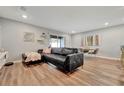 Comfortable living room with modern decor, black leather couch, and ample natural light at 3086 Fieldwood Cir, St Cloud, FL 34772