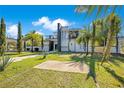 Contemporary two-story home with lush landscaping and a spacious front yard at 34500 Tree Frog Ln, Eustis, FL 32736