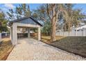 View of the detached carport highlighting the ample parking space and backyard access at 355 Anderson Dr, Groveland, FL 34736