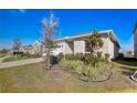 Well-maintained home showing the manicured lawn, mature landscaping, and inviting curb appeal at 362 Sofia Ln, Lake Alfred, FL 33850