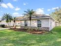 This home boasts lovely landscaping with mature trees, attractive brick accents, and well-kept grounds at 4087 Clock Tower Dr, Port Orange, FL 32129