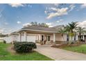 Beautiful home featuring an attached carport, fresh landscaping, and a charming front entrance at 4087 Clock Tower Dr, Port Orange, FL 32129