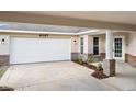 Attached carport offers ample parking with a brick accent wall and pathway to the front door at 4087 Clock Tower Dr, Port Orange, FL 32129