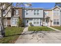 Inviting townhome exterior with well-maintained lawn and convenient parking area at 483 Green Spring Cir, Winter Springs, FL 32708